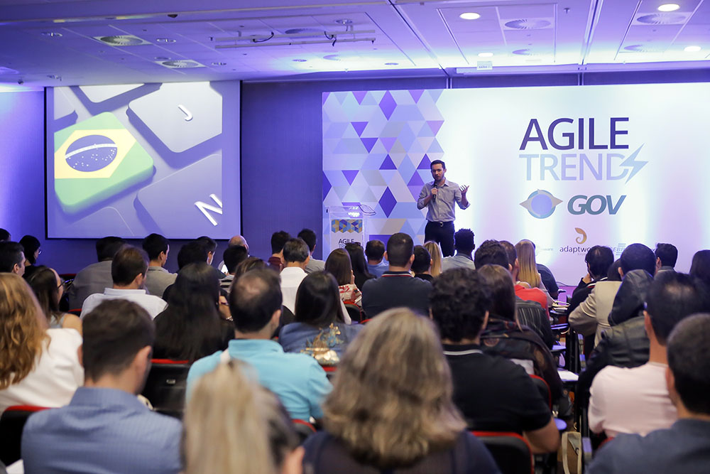 Dairton Bassi de frente à plateia fazendo a abertura oficial do evento Agile Trends Gov 2018